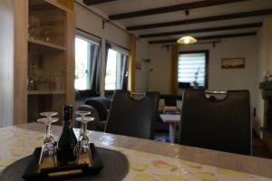 a table with two bottles and glasses on it at Haus Waldfrieden EG in Thalfang