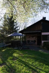 a patio with an umbrella next to a building at Haus Waldfrieden OG in Thalfang