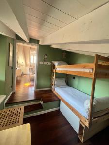 two bunk beds in a room with a hallway at Vanessa's Art Rooftop Attic - City View - San Fedele, Historic Center Como in Como
