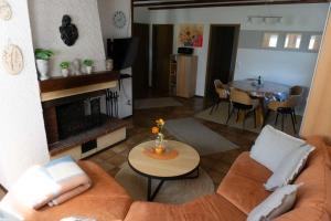 a living room with a couch and a table at Haus Sonnenblick in Thalfang