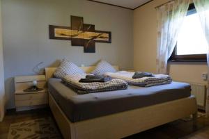 a bedroom with a bed with two pillows on it at Haus Sonnenblick in Thalfang
