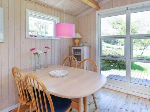 a dining room with a table and chairs at 5 person holiday home in Stege in Stege