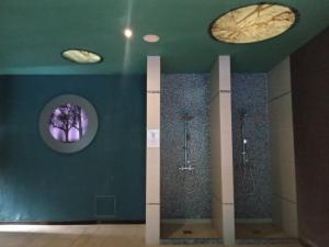 a bathroom with three urinals and three sinks in a room at Studio SimpaKop in Kopaonik