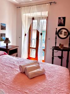 a bedroom with a bed with two towels on it at LA GROTTA Guest House Subiaco in Subiaco