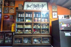 a display case in a store with bottles of alcohol at Tapae Inn in Chiang Mai