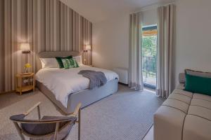 a hotel room with a bed and a couch at Casa do Rio in Mondim de Basto +109 photos