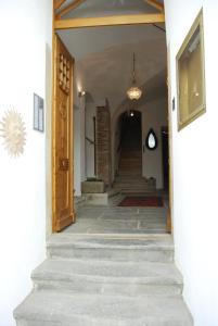 a hallway with stairs leading to a building with a clock at Gasthof Zur Goldenen Sonne in Passau