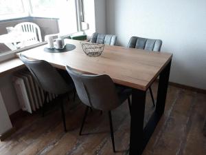 a dining room table with four chairs around it at Ferienwohnung Pfeiffer klein in Sankt Andreasberg