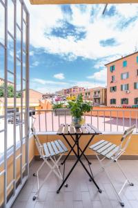 a table and chairs on a balcony with a view at Luxury Station Oasis with Balcony in Bologna