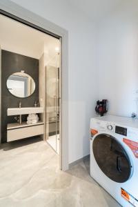 a washing machine in a bathroom with a mirror at Luxury Station Oasis with Balcony in Bologna +28 photos