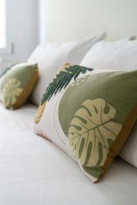 a bed with three pillows on it at Luxury Station Oasis with Balcony in Bologna