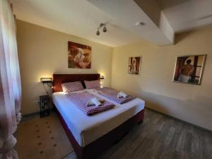 a bedroom with a bed with two pillows on it at Haus Blumengarten in Thalfang