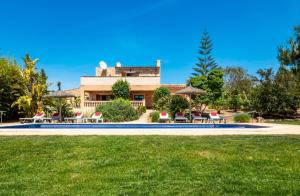 a house with a pool in front of a building at Finca Peris in Caʼs Concos