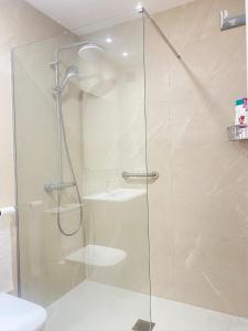 a shower with a glass door in a bathroom at Beach house with pool at the Fortí viewpoint in Altafulla