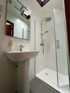 a bathroom with a sink and a shower at Private Room in Old Town in Viana do Castelo