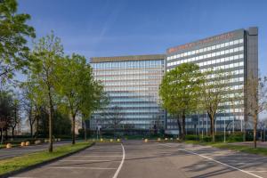 an empty parking lot in front of a building at Crowne Plaza Milan Linate by IHG in San Donato Milanese