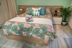 a bedroom with a bed with towels on it at Atico En Faro in Roquetas de Mar +15 photos