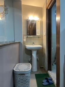 a bathroom with a sink and a mirror at Hostmandu Homes at Chris BnB in Jawlakhel +5 photos