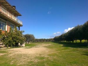 a large field of grass next to a building at Camera singola in affitto con bagno privato interno in Montenero di Bisaccia