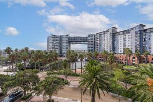 a large city with tall buildings and palm trees at Manhattan Suite-Canal Walk Mall in Cape Town