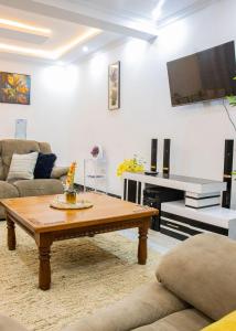 a living room with a coffee table and a flat screen tv at Naivasha Vacation Homes - Villaview in Naivasha