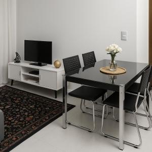 a black dining room table with chairs and a tv at Novo apartamento Smart em São Paulo Pirituba in Sao Paulo