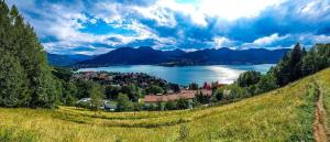 a view of a lake and a town on a hill at Apartment Schildenstein in Rottach-Egern