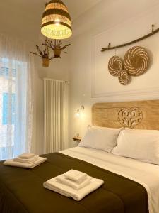 a bedroom with a bed with two towels on it at Il Re degli Scalzi in Matera +88 photos