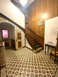 a hallway with a staircase and a floor at Le Trèfle de l'Impériale in Sermizelles
