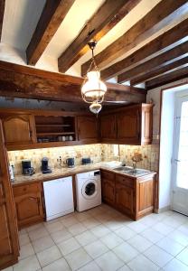 a kitchen with a washer and dryer in it at Le Trèfle de l'Impériale-Les gites de l imperiale in Sermizelles