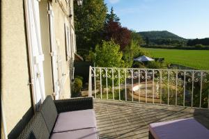 a balcony of a house with a view of a garden at Le Trèfle de l'Impériale-Les gites de l imperiale in Sermizelles
