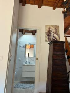 a bathroom with a shower and a sink and a mirror at Little Lake Escape in Olgiasca
