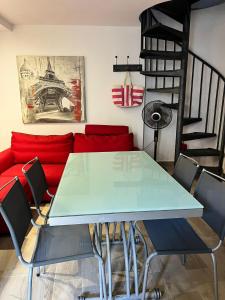 a living room with a table and a red couch at Little Lake Escape in Olgiasca