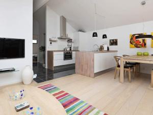 a kitchen and living room with a table and a dining room at 4 star holiday home in Bogense in Bogense +40 photos