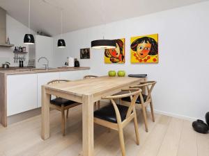 a dining room with a wooden table and chairs at 4 star holiday home in Bogense in Bogense