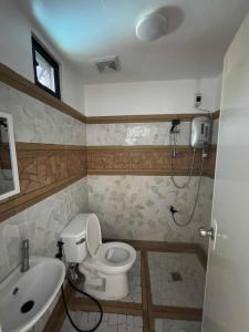 a bathroom with a toilet and a sink at Stefanie Grace Inn in Loboc +86 photos