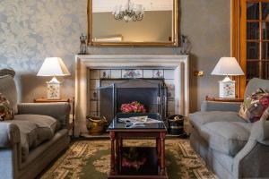 a living room with two couches and a fireplace at The Open Arms Hotel in Dirleton
