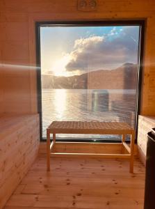 OltedalにあるCabin with beach and sauna 18 min PreikestoIenの小屋の窓とその前にベンチがある