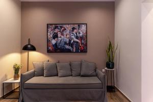 a living room with a couch and a painting on the wall at Vagabond Guesthouse in Athens +9 photos