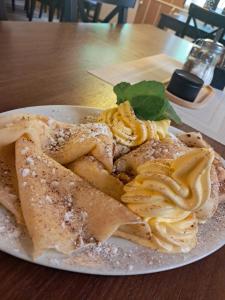 a plate of food on a wooden table at Penzion a restaurace Windows in Mařenice