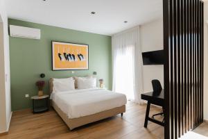 a bedroom with a bed and a desk in it at Vagabond Guesthouse in Athens