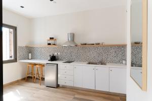 a kitchen with white cabinets and a counter at Vagabond Guesthouse in Athens
