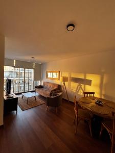a living room with a couch and a table at Frente al mar in Montevideo