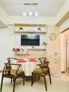 a dining room with a table and two chairs at Cozy 1-Bedroom Retreat in Iloilo City with City Views in Molo
