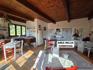 a living room with a table and chairs in it at Acquaviva - By Ligooria in Tovo San Giacomo