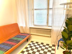 a room with a bench in front of a window at Nordic Modern, Kamppi in Helsinki
