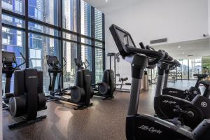 a gym with treadmills and ellipticals in a building at Luxe 3BR Skyline Sunset Residence Level 63 - CBD Views, Parking, Pool, Sauna, Gym in Melbourne