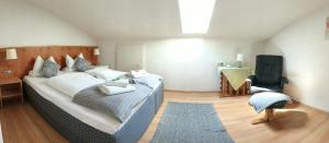 a bedroom with a bed and a desk and a chair at fewolehr in Ulm