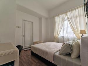 Katil atau katil-katil dalam bilik di Urban Oasis Apartment 7 One
