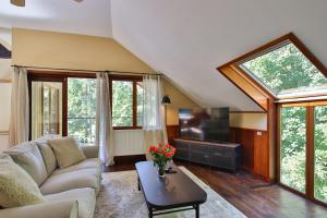 a living room with a couch and a tv at Gite Moments à Soy in Soy